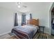Cozy bedroom with natural light, a ceiling fan, and a double bed with a striped blanket at 3260 Pinetree St, Port Charlotte, FL 33952