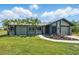 Charming single-story home with a well-maintained lawn, palm trees, and an inviting walkway leading to the front door at 3260 Pinetree St, Port Charlotte, FL 33952