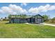 Charming home boasts a landscaped front yard with palm trees and a well-manicured lawn at 3260 Pinetree St, Port Charlotte, FL 33952