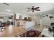 Open kitchen featuring a large island, modern appliances, white cabinets, and wood-look flooring at 3260 Pinetree St, Port Charlotte, FL 33952