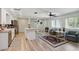 Spacious living area with wood-look flooring, a ceiling fan, and a decorative rug at 3260 Pinetree St, Port Charlotte, FL 33952