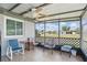 Screened porch with tile floors has seating for four and views of a well-maintained neighborhood at 3260 Pinetree St, Port Charlotte, FL 33952