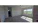 The bedroom is filled with light from a window, which features ceramic tile flooring and a view of the outdoors at 3531 Night Star Ter, Parrish, FL 34219
