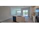 Bright open kitchen with white cabinetry, a center island, stainless appliances, and a view to the lanai at 3531 Night Star Ter, Parrish, FL 34219