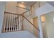 Bright stairway with wooden banisters and white balusters ascends to the upper level of the home at 3531 Night Star Ter, Parrish, FL 34219