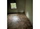 Unfurnished bedroom space with aged floors, window, and bare walls at 3619 18Th E St, Bradenton, FL 34208