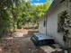 Exterior of a house with white siding, surrounded by greenery and trees at 3619 18Th E St, Bradenton, FL 34208