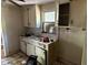 Shows kitchen with aging cabinets, sink area, and window view at 3619 18Th E St, Bradenton, FL 34208