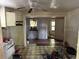 Open kitchen area shows dated cabinetry, worn flooring, and connected rooms at 3619 18Th E St, Bradenton, FL 34208
