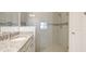 Bright bathroom features granite counters, tiled shower with glass door, and stylish fixtures at 3684 Fescue Ln, Sarasota, FL 34232