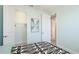 This bedroom features doors to the closet and bathroom plus coastal-themed wall art at 3684 Fescue Ln, Sarasota, FL 34232