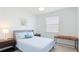 Cozy bedroom with natural light, comfortable bed, and stylish decor at 3684 Fescue Ln, Sarasota, FL 34232