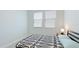 This bedroom has two windows and a black and white patterned comforter at 3684 Fescue Ln, Sarasota, FL 34232