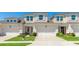 Inviting townhouse exterior with brick driveway, two-car garage, and manicured landscaping at 3684 Fescue Ln, Sarasota, FL 34232