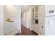 Cozy hallway with wood floors and built-in display cabinet, leading to the main living areas at 3684 Fescue Ln, Sarasota, FL 34232