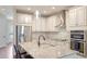 Contemporary kitchen with stainless steel appliances, granite countertops, and white cabinetry at 3684 Fescue Ln, Sarasota, FL 34232