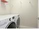 This laundry room has a modern washer and dryer set with a shelf above at 3684 Fescue Ln, Sarasota, FL 34232