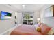 Relaxing main bedroom featuring ceiling fan, ensuite bathroom, and view of the lanai at 3684 Fescue Ln, Sarasota, FL 34232