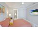 Comfortable main bedroom featuring a ceiling fan, television, and ensuite bathroom at 3684 Fescue Ln, Sarasota, FL 34232