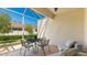 Enclosed patio with a brick floor, comfortable seating, and privacy landscaping creating an outdoor room at 3684 Fescue Ln, Sarasota, FL 34232