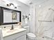 Well-lit bathroom featuring a modern vanity, decorative mirror, and walk-in shower at 3730 Cadbury Cir # 631, Venice, FL 34293