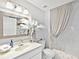 Bright bathroom featuring a vanity, decorative mirror, and shower with stylish curtain at 3730 Cadbury Cir # 631, Venice, FL 34293