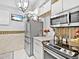 Modern kitchen with stainless steel appliances, quartz countertops, and ample storage at 3730 Cadbury Cir # 631, Venice, FL 34293