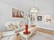 Elegant living room with a decorative chandelier and neutral decor at 3730 Cadbury Cir # 631, Venice, FL 34293