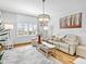 Bright living room with hardwood floors, comfortable seating, and abundant natural light at 3730 Cadbury Cir # 631, Venice, FL 34293
