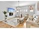 Comfortable living room featuring a mounted TV, electric fireplace, and cozy decor at 3730 Cadbury Cir # 631, Venice, FL 34293