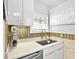 Close up of the kitchen sink featuring modern finishes and a mosaic backsplash at 3730 Cadbury Cir # 631, Venice, FL 34293