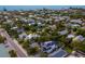 Beautiful aerial view showcasing a neighborhood near the beach with lush greenery and a view of the ocean at 408 Magnolia Ave, Anna Maria, FL 34216