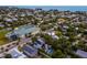 Beautiful aerial view of the home in a community with tennis courts and a glimpse of the ocean at 408 Magnolia Ave, Anna Maria, FL 34216