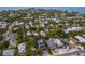 Scenic aerial view of a neighborhood, featuring homes, lush greenery, and distant ocean views at 408 Magnolia Ave, Anna Maria, FL 34216
