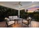 Outdoor living area with sunset views, comfortable seating, and a ceiling fan at 408 Magnolia Ave, Anna Maria, FL 34216