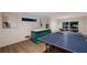 Spacious basement entertainment area features a ping pong table, air hockey table, and stylish wet bar at 408 Magnolia Ave, Anna Maria, FL 34216