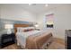 Comfortable bedroom with a woven headboard, ambient lighting, and modern decor at 408 Magnolia Ave, Anna Maria, FL 34216