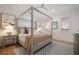 Serene bedroom featuring a four-poster bed, soft lighting, and calming neutral tones at 408 Magnolia Ave, Anna Maria, FL 34216