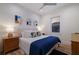 Bright bedroom with modern artwork, light-colored walls, and wood flooring at 408 Magnolia Ave, Anna Maria, FL 34216