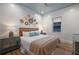 Cozy bedroom with white shiplap walls, woven decor, and a blue-painted ceiling at 408 Magnolia Ave, Anna Maria, FL 34216