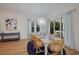 Elegantly staged dining room with seating for six, stylish decor, and natural light at 408 Magnolia Ave, Anna Maria, FL 34216