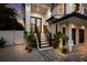 Charming home exterior featuring well-maintained stairs and landscaped front yard at 408 Magnolia Ave, Anna Maria, FL 34216