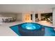 Elegant pool and hot tub area with covered patio and outdoor seating at 408 Magnolia Ave, Anna Maria, FL 34216