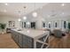 Bright, spacious kitchen with a large island, quartz countertops, and modern pendant lighting at 408 Magnolia Ave, Anna Maria, FL 34216