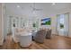 Bright living room featuring stylish furniture, ample natural light, and a mounted flatscreen TV at 408 Magnolia Ave, Anna Maria, FL 34216