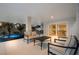 This covered patio features stylish seating with lovely views of the pool, spa, tropical backyard and indoor space at 408 Magnolia Ave, Anna Maria, FL 34216