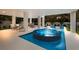 Stunning pool with integrated hot tub, lounge chairs, and lush landscaping at 408 Magnolia Ave, Anna Maria, FL 34216