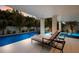 Tranquil poolside lounge area with comfortable seating and lush tropical landscaping at 408 Magnolia Ave, Anna Maria, FL 34216