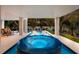 Beautiful pool area featuring a modern hot tub and stylish lounge furniture at 408 Magnolia Ave, Anna Maria, FL 34216