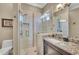 Bathroom with granite countertop, glass shower, and modern fixtures at 416 Casey Key Rd, Nokomis, FL 34275